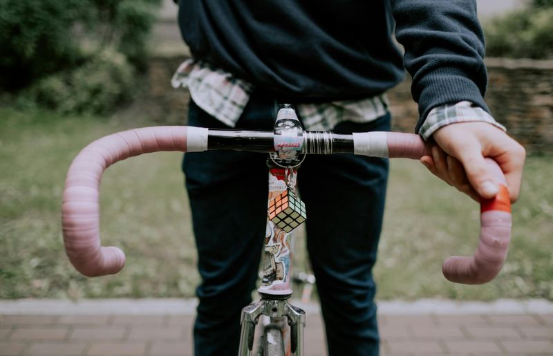 Close-up of a man's hands gripping the floor during a plank exercise.