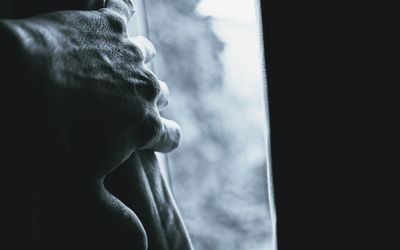 Silhouette of a person in a balancing pose against a dark background.